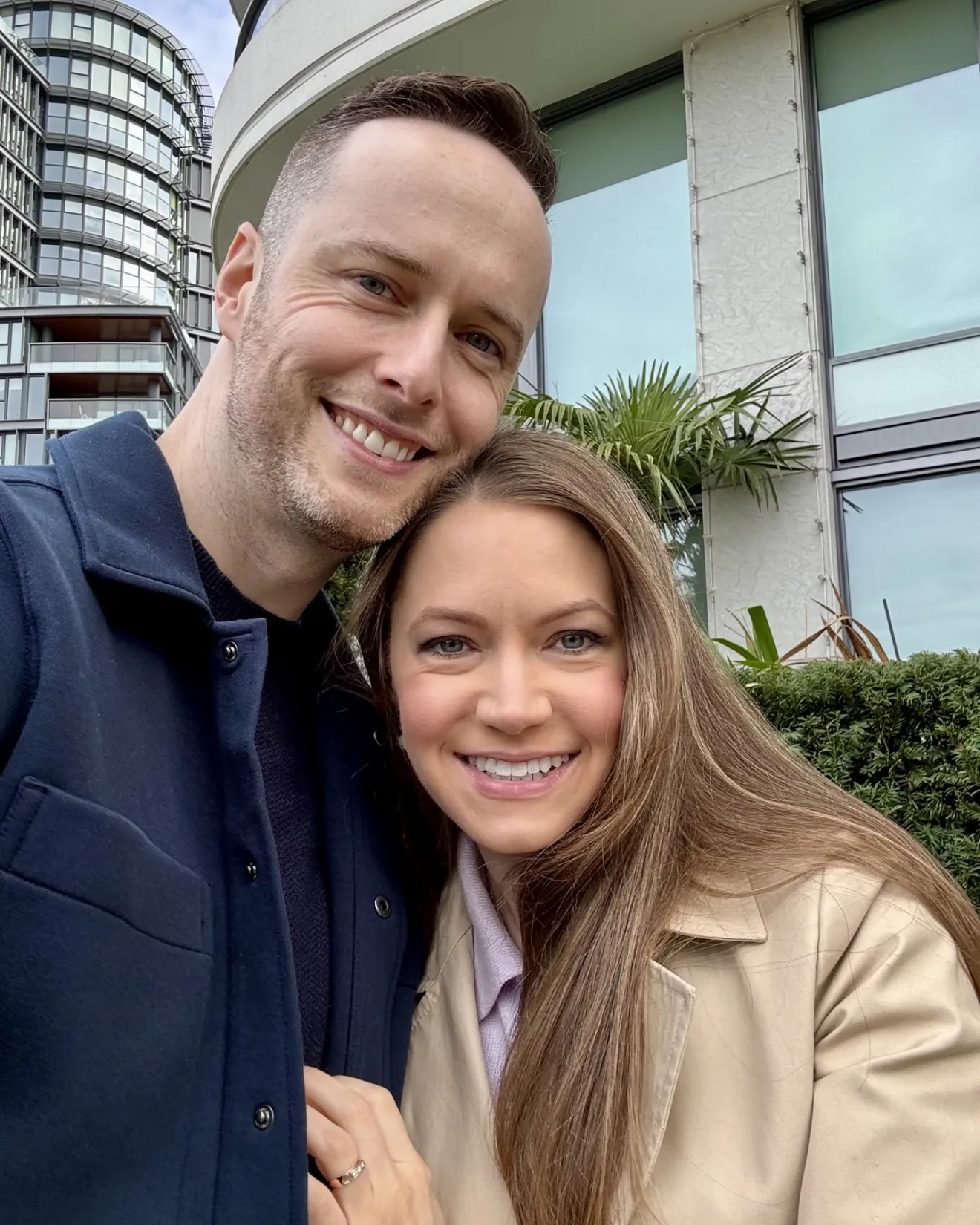 Jeffrey and Maria, smiling, outside on a cloudy day